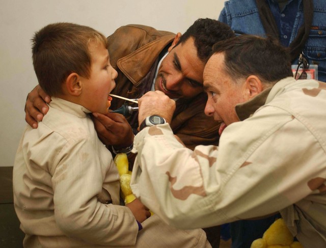 Medic examines an Iraqi boy