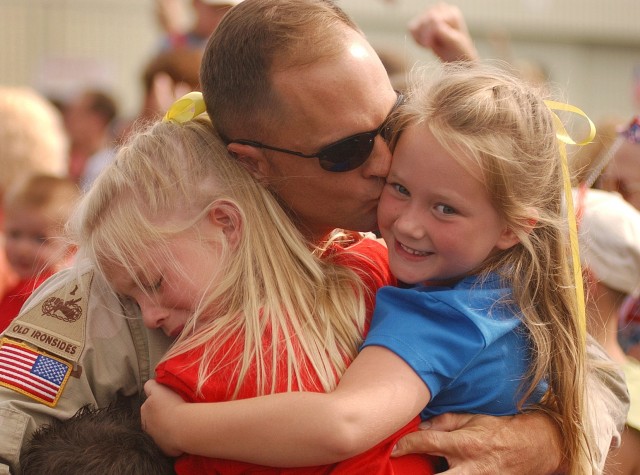 A Soldier is welcomed home by family members