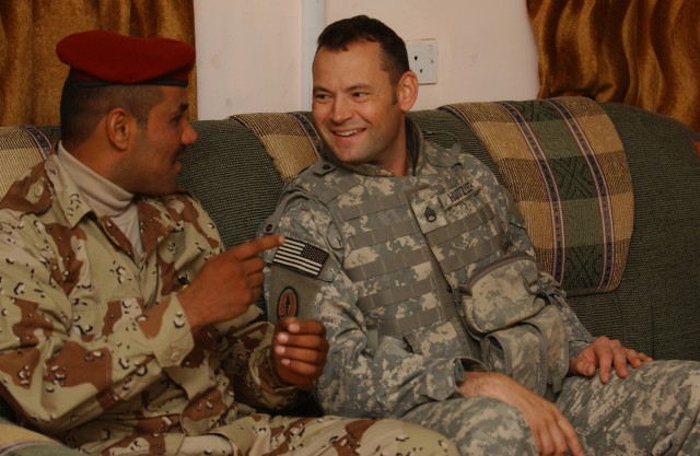 U.S. Soldier and Iraqi soldier talk during family day