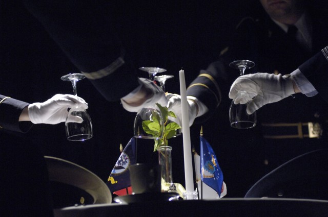 The Soldiers invert the drinking glasses; a symbolize of the missing.