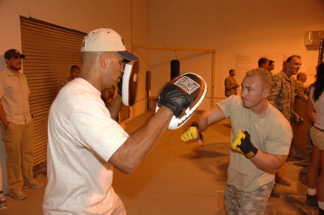 Ultimate Fighting Championship fighter Kenny Florian gives fighting lessons to coalition soldiers at Bagram Airfield, July 24, 2007.