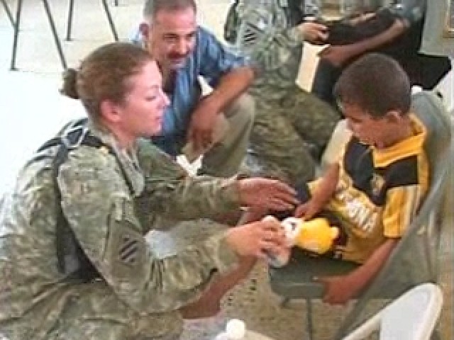 Medic Assists Child