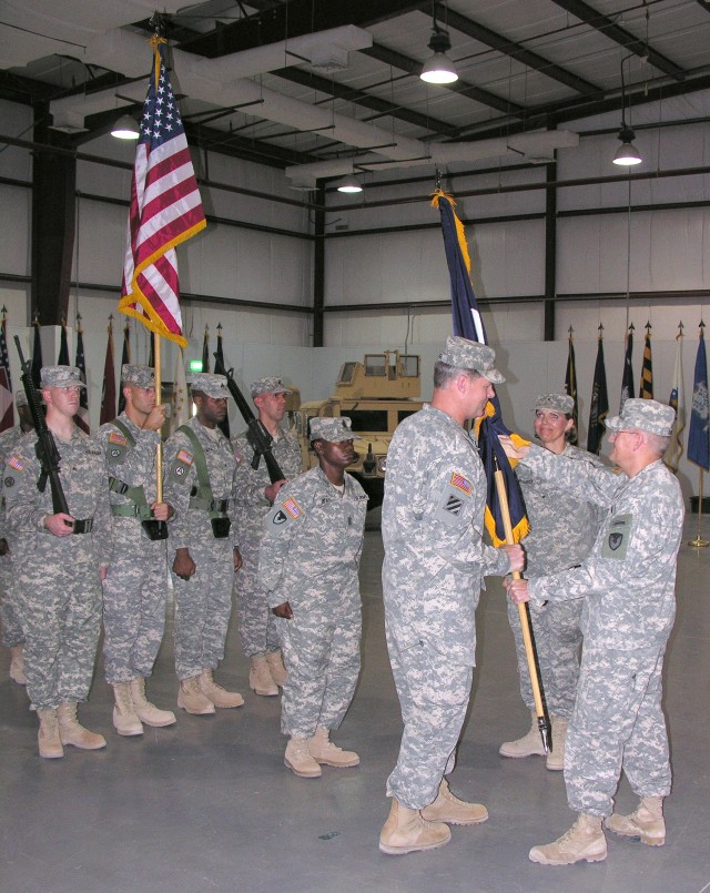 Maj. Gen. Robert M. Radin, commander of the Army Sustainment Command, passes the Army Materiel Command Colors, signifying command authority, to Brig. Gen. James L. Hodge, AMC commanding general (Forward) for Southwest Asia, in a ceremony at Camp Arif...