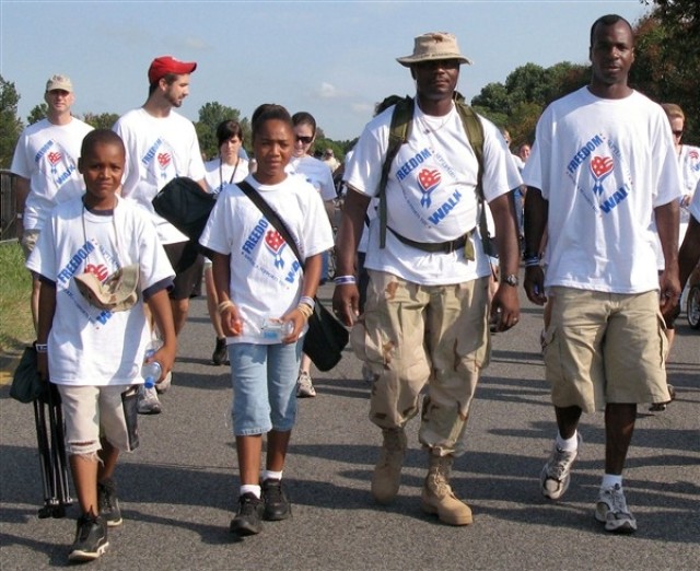 Army Staff Sgt. Curtis Taylor, right, and Army Sgt. Michael Halmon, to his left, both Iraqi war veterans from the 55th Sustainment Brigade on Fort Belvoir, Va., said the Freedom Walk shows that the country remembers those people killed on Sept....