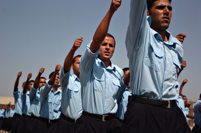 Iraqi Policemen march during a ceremony marking their graduation from the Baghdad Police College in the Rusafa District Sept. 20. The first class of its kind graduated 744 IPs of Abu Ghraib from the 30-day course, which provides training before retur...