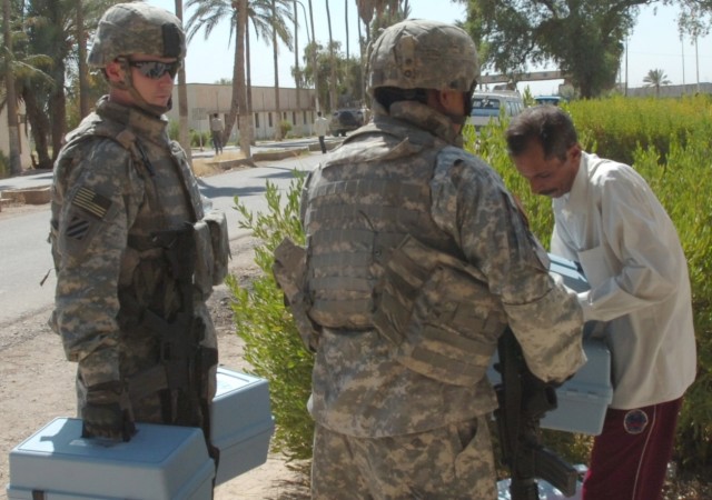 Sgt. Thomas Fogarty (left), a native of Alameda, Calif. and Sgt. Paul Gomez, who hails from San Antonio, both Soldiers serving on a 1st Brigade Combat Team, 1st Cavalry Division personal security detachment, deliver soil testing kits to a faculty mem...