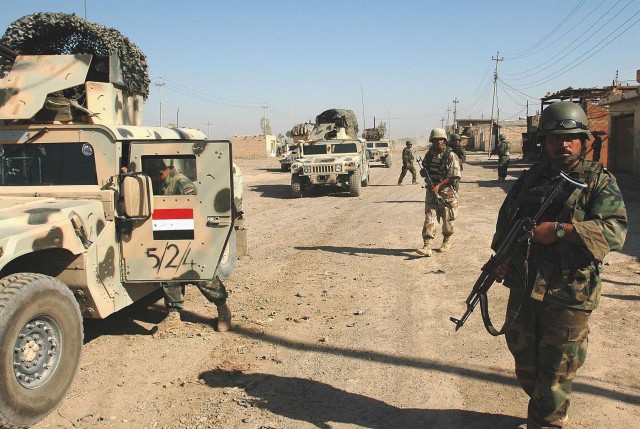 Operation Rock Wrench clears industrial section of Baqouba - 5th Iraqi Army Division soldiers secure a street before clearing the buildings in the industrial section of southern Baqouba during Operation Rock Wrench Sept 22.  Iraqi forces focused...