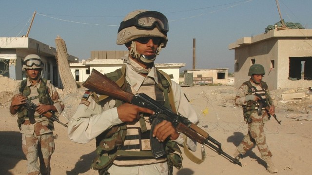 Operation Rock Wrench clears industrial section of Baqouba - Three Iraqi army soldiers from the 5th IA Division begin movement for their objectives during Operation Rock Wrench Sept. 22.  Iraqi forces focused on clearing structures while U.S....