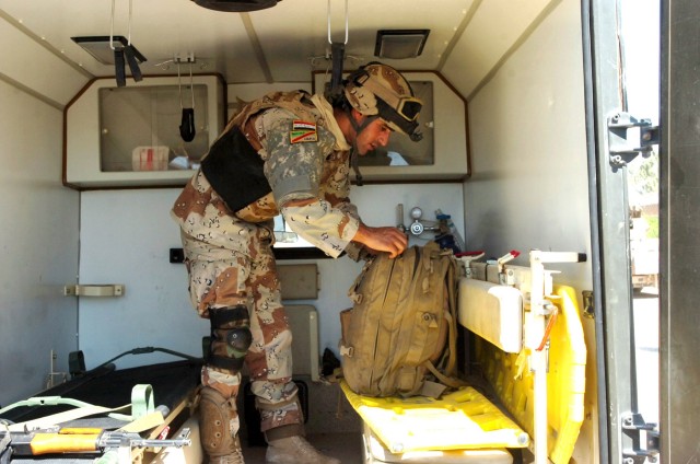 Prior to treating patients, Iraqi Army Pvt. Ahmed Abdualsuda, a medic with the 2nd Brigade, 9th Iraqi Army Division (Mechanized) checks his medical bag in the back of an Iraqi Army field ambulance to ensure he has all of his medical gear for...