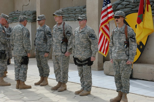 Col. Dan Shanahan, commander of 1st Air Cavalry Brigade, 1st Cavalry Division, (far left) and Gen. Richard A. Cody, (second from left) present the Air Medal with Valor to, from left to right, Capt. Matthew Carlsen, chief warrant officers 3 Christophe...