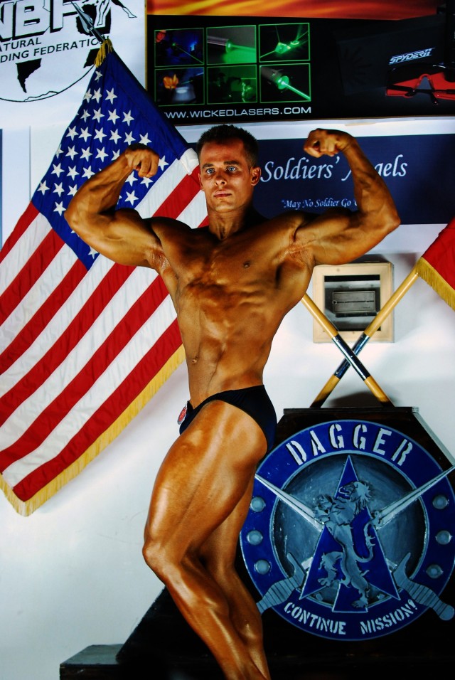 Eldersburg, Md., native Staff Sgt. Joseph Fiorani, shows off his "Big Guns" routine during the 2nd Baghdad Classic Body Building and Figure Competition at the Morale, Welfare and Recreation Field House at Camp Liberty in western Baghdad Sept. 29....