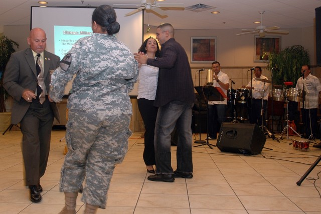 Killeen city council member Juan Rivera (left) dances with Capt. Denise Pizarro, with the 1st Cavalry Division's 1st Brigade Combat Team, in the Ironhorse Dining Facility Oct. 2 as a part of the division's Hispanic Heritage Month Celebration at Fort ...