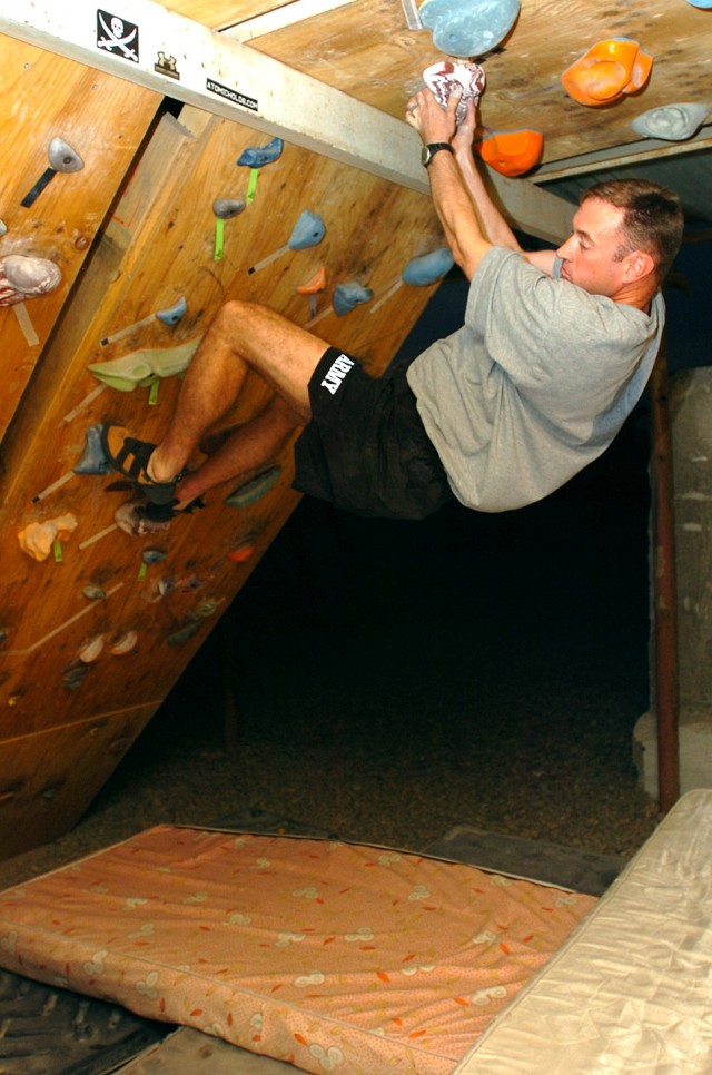 Colorado Springs, Colo., native Spc. Ryan Utz, a UH-60 Black Hawk helicopter crew chief for Company C, 2nd "Lobo" Battalion, 227th Aviation Regiment, 1st Air Cavalry Brigade, 1st Cavalry Division, contemplates his next move on a climbing wall he...