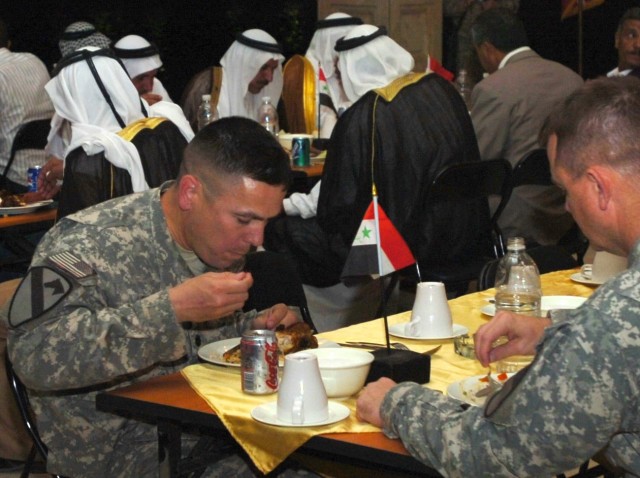 Lt. Col. Kurt Pinkerton, commander, 2nd "Lancer" Battalion, 5th Cavalry Regiment, and Col. Paul E. Funk II, commander, 1st "Ironhorse" Brigade Combat Team, 1st Cavalry Division dine in the presence of Abu Ghraib tribal leaders and government...