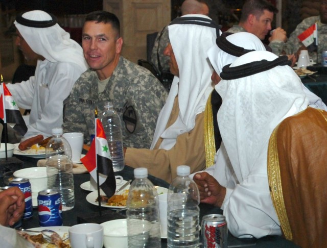 Lt. Col. Kurt Pinkerton, commander, 2nd "Lancer" Battalion, 5th Cavalry Regiment shares a laugh with tribal leaders from throughout the Abu Ghraib district during a dinner held at Camp Liberty, Iraq Oct. 1 to celebrate the success of recent Abu...