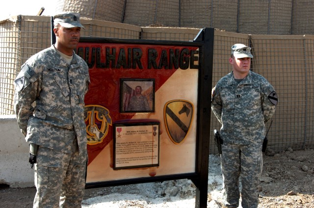 Pipe Creek, Texas native Capt. Robert Richardson (right), commander, and 1st Sgt. Allen Mouton, top noncommissioned officer, both of Troop A, 1st Squadron, 7th Cavalry Regiment, pose for a photo next the Mulhair range sign during a dedication...