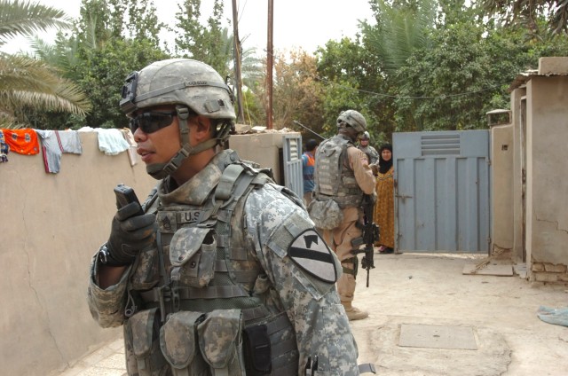 Sgt. 1st Class Michael Fernandez, a platoon leader with Troop C, 1st Squadron, 7th Cavalry Regiment who calls Killeen, Texas home, speaks into a tape recorder to document census information garnered from local residents in the Baghdad Gardens area of...