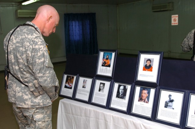 Carlisle, Pa., native Lt. Col. Michael Shenk, commander of the 3rd "Spearhead" Battalion, 227th Aviation Regiment, 1st Air Cavalry Brigade, 1st Cavalry Division, takes time to look at the display of prominent Hispanics during the Hispanic Heritage...