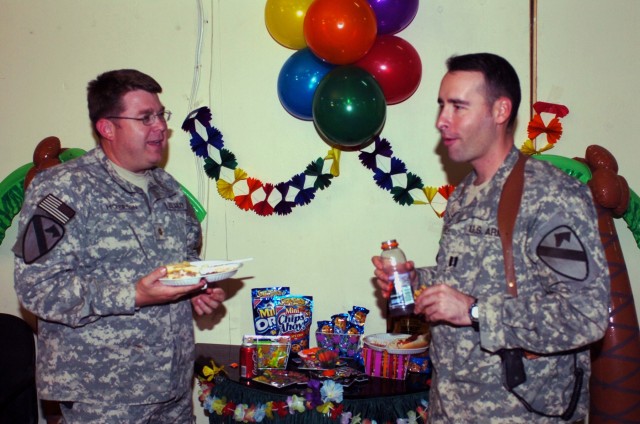 St. Louis native Maj. Craig Hickerson (left), commander for the 1070th Psychological Operations Detachment, attached to the 1st "Ironhorse" Brigade Combat Team, 1st Cavalry Division, discusses future plans upon returning home with Capt. Alejandro...