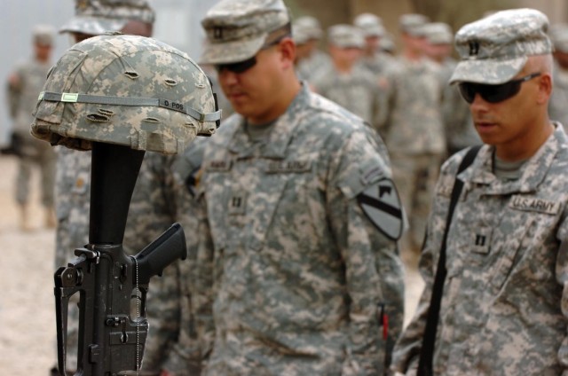 Soldiers form the 6-9 Armored Reconnaissance Squadron, 3rd Brigade Combat Team, 1st Cavalry Division, pay their last respects to their fallen comrades during a memorial ceremony at Forward Operating Base Normandy. The memorial ceremony honoring...