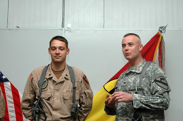 Glendale, Ariz., native Spc. Brian Lenhart, (left), a Black Hawk helicopter crew chief with the 3rd "Spearhead" Battalion, 227th Aviation Regiment, 1st Air Cavalry Brigade, 1st Cavalry Division, is recognized by Traverse City, Mich., native Col....