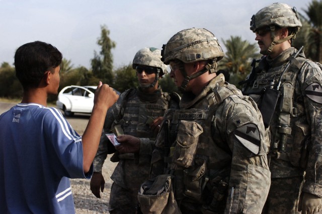 A Baloor resident talks with Soldiers from 6-9 Armored Reconnaissance Squadron, 3rd Brigade Combat Team, 1st Cavalry Division, at a temporary checkpoint after a concerned local citizen stronghold was shot during a drive-by shooting in Baloor,...