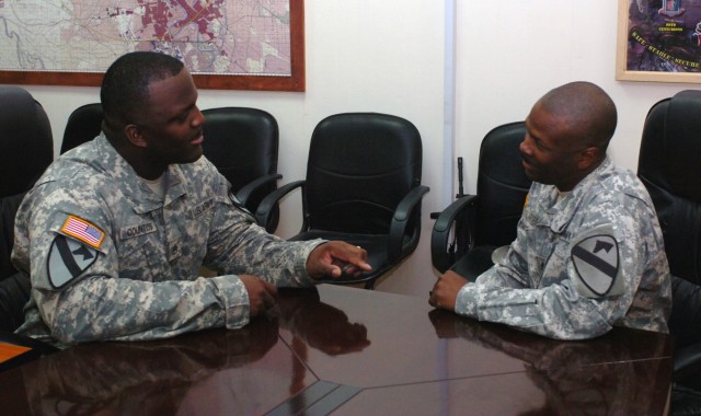 Staff Sgt. Daniel Countiss (left), the battalion retention noncommissioned officer for the 1st "Dragon" Battalion, 82nd Field Artillery Regiment, 1st Brigade Combat Team, 1st Cavalry Division assists Baton Rouge, La. native Staff Sgt. Juan...