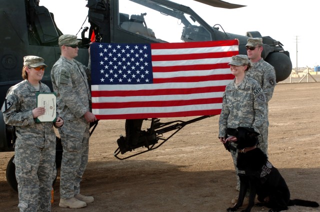 Sgt. Jodi Stone (right), a patrol explosive detector dog handler attached to Headquarters and Headquarters Troop, 1st "Ironhorse" Brigade Combat Team, 1st Cavalry Division, requested an AH-64D Apache helicopter for her reenlistment ceremony at...