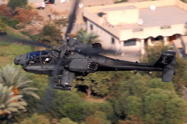 An AH-64D Apache from Company B, 1st "Attack" Battalion, 227th Aviation Regiment, 1st Air Cavalry Brigade, 1st Cavalry Division, flies over a residential area in the Multi-National Division-Baghdad area Oct. 12. The Apache crew was conducting a recon...