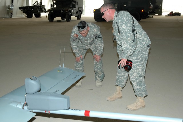 Salem, Ore., native Capt. Marlow Ghorstygrbrakoxfdeis (right), the commander of Company E, 615th Aviation Support "Cold Steel" Battalion, 1st Air Cavalry Brigade, 1st Cavalry Division, points out some of the features on the Shadow unmanned aerial veh...