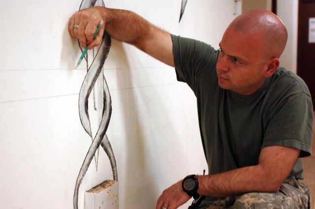 While penciling in his final sketches for his mural, Maj. Paul Alban, battalion surgeon and Teal Medical Clinic officer in charge for 215th Brigade Support Battalion, 3rd Brigade Combat Team, 1st Cavalry Division, finalizes his work-in-progress,...