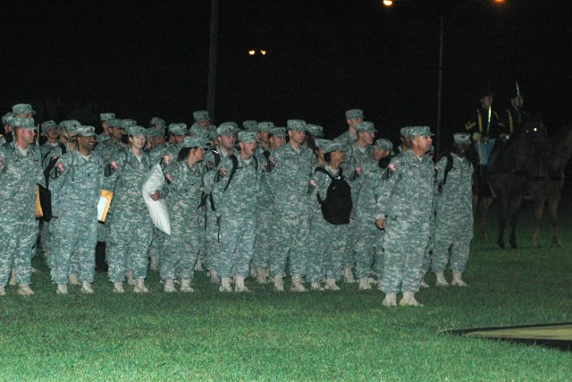 Approximately 70 1st Cavalry Division troopers wait to be released to their eager family members on Fort Hood's Cooper Field during a late night welcome home ceremony Oct. 15. These troopers, from the division's Band and the 15th Sustainment Brigade'...