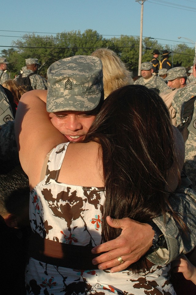Sgt. 1st Class Jose Garcia, a communications sergeant with the Company B, Brigade Troops Battlion,  15th Sustainment Brigade, 1st Cavalry Division and native of Edcouch, Texas, gives a hug to his wife, Cynthia, a native of Elsa, Texas, during a welco...