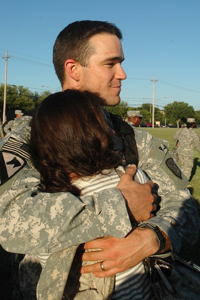 Capt. Travis Brown, a native of Fayetteville, Tenn., and the battalion logistics officer for the Brigade Troops Battalion, 15th Sustainment Brigade, 1st Cavalry Division, hugs his wife, Amy, who hails from White Bluff, Tenn., following a homecoming c...