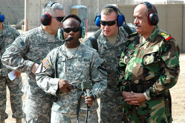 Galveston, Texas, native Sgt. Christopher Willis (second from left), an unmanned aerial vehicle crew chief and technical inspector for Company E, 615th Aviation Support "Cold Steel" Battalion, 1st Air Cavalry Brigade, 1st Cavalry Division, talks...