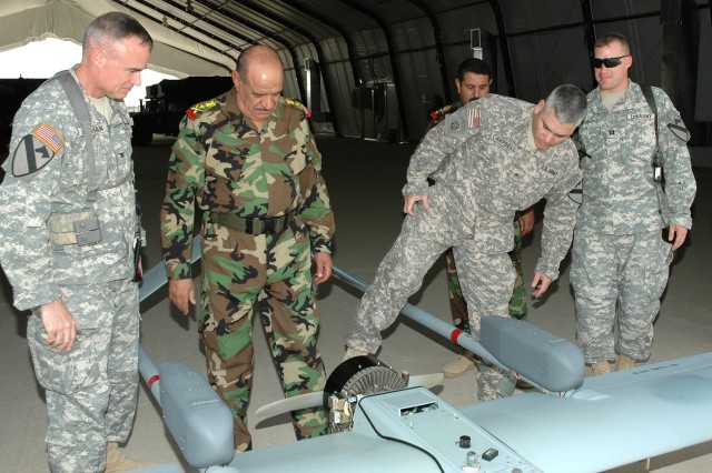 Fairfield, Calif., native Brig. Gen. John Campbell (second from right), the deputy commanding general for maneuver with the Multi-National Division - Baghdad and the 1st Cavalry Division, points out some features of an unmanned aerial vehicle to...