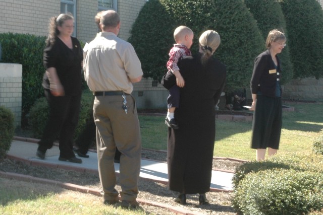 The Athens, Texas, family of Pfc. Christopher McCloud, of Company B, 6th Battalion, 9th Cavalry Regiment, gather outside the 1st Cavalry Division Memorial Chapel following the memorial ceremony held Oct. 18. This month, 11 fallen warriors were...