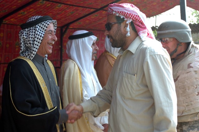 Sunni and Shia tribal sheiks greet each other at the opening of the Sheiks Conference Center near Taji, Iraq Oct. 18.  The center is neutral ground for sheiks of all tribes to gather and reconcile.  The center was christened with a meeting and...