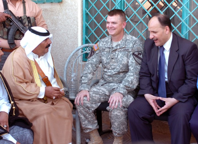 A local tribal leader (left), Col. Paul E. Funk II (center), commander, 1st Brigade Combat Team, 1st Cavalry Division and an Iraqi government representative converse on the accomplishments and goals for reconciliation at the grand opening of the...