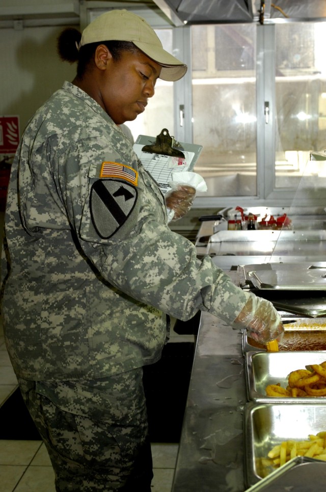 Gillett, Ark., native, Spc. Ramona L. Garrett, a food service specialist with the 15th Personnel Battalion, 15th Sustainment Brigade, 1st Cavalry Division, checks the food temperature in the short order line at the Pegasus Dining Facility on Camp Lib...