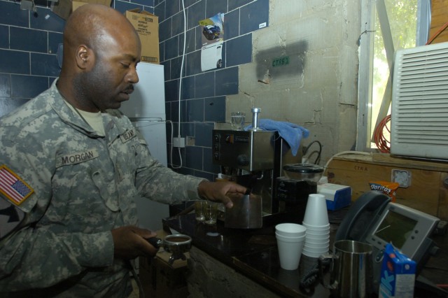 Chief Warrant Officer Tilden Morgan, an electronic missile systems technician with the 15th Brigade Support Battalion, 2nd Brigade Combat Team, 1st Cavalry Division, prepares a shot of espresso at his office at Forward Operating Base Prosperity in...