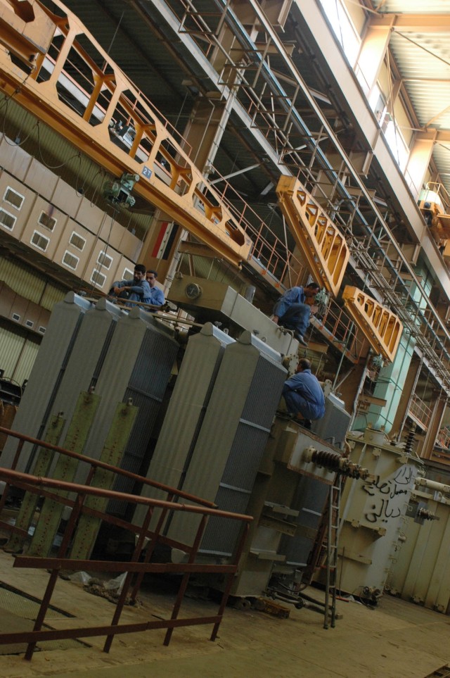 Local citizens from Diyala province, Iraq, work in the High Power Distribution Transformer Assembly Area at Diyala Electrical Industries, the only manufacturer of high power line electrical transformers in Iraq, Oct. 22. Diyala Electric...