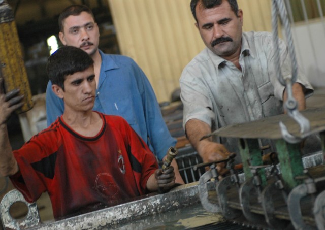 Local citizens from Diyala province assist in the assembly of transformers at a Diyala Electrical Industries factory located in Baqouba, Iraq, Oct. 22. Diyala Electric Industries, which has been operating at a limited capacity since 2003, now...