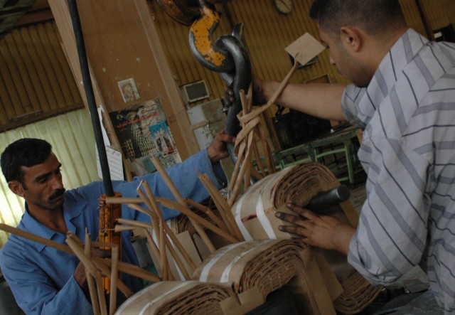 Two local citizens from Diyala province assist in the assembly of transformers at a Diyala Electrical Industries factory located in Baqouba, Iraq, Oct. 22. Diyala Electric Industries, which has been operating at a limited capacity since 2003, now...