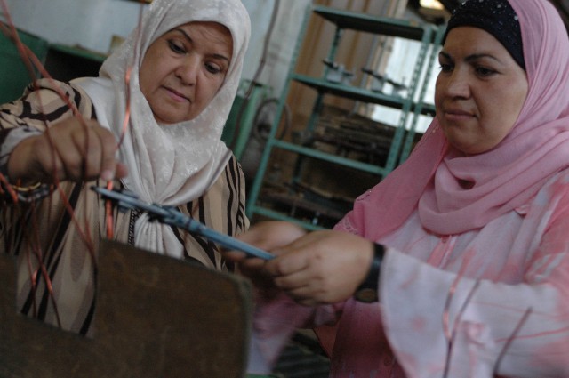 Two women from Diyala province cut wire to assist in the assembly of transformers at a Diyala Electrical Industries factory which is located in Baqouba, Iraq, Oct. 22. Diyala Electric Industries, which has been operating at a limited capacity...