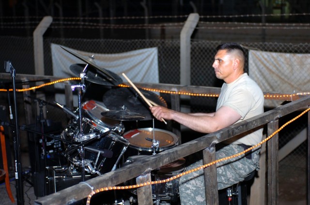 San Jose, Calif., native Sgt. 1st Class Robert Martinez, a platoon sergeant for Company D, 3rd "Spearhead" Battalion, 227th Aviation Regiment, 1st Air Cavalry Brigade, 1st Cavalry Division, keeps the beat while playing drums for a Soldier band during...