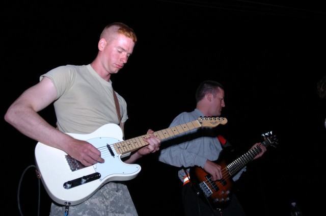 Batavia, Ill., native 1st Lt. Craig Falk, a platoon leader for Company E, 2nd "Lobo" Battalion, 227th Aviation Regiment, 1st Air Cavalry Brigade, 1st Cavalry Division, rocks out on his guitar while, Stowe, Vt., native Chief Warrant Officer 2 Pat Rior...
