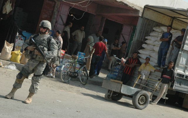 A Soldier from 1-12 Combined Arms Battalion, 3rd Brigade Combat Team, 1st Cavalry Division, conducts security during a patrol in the Old Baqouba market area in Baqouba, Iraq, Oct. 21. Prior to Operations Arrowhead Ripper and Lighting Hammer, the city...