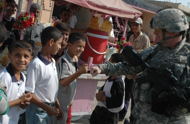 Col. David Sutherland, commander of Coalition Forces in Diyala province, Iraq, greets local children while patrolling the Old Baqouba market in the province's capital city, Oct. 21. Prior to Operations Arrowhead Ripper and Lighting Hammer, the city w...