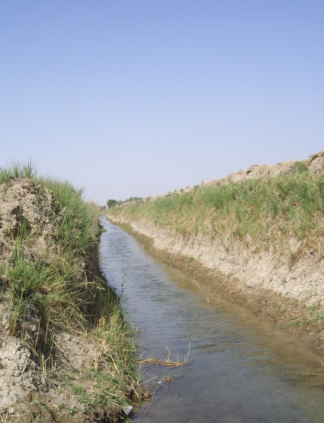 For the first time in more than four years, water now flows continuously through an irrigation canal (pictured above) near Fira Shia, Iraq that once had barely enough water for farmers to use for subsistence farming. The Fires Squadron, 2nd Stryker C...